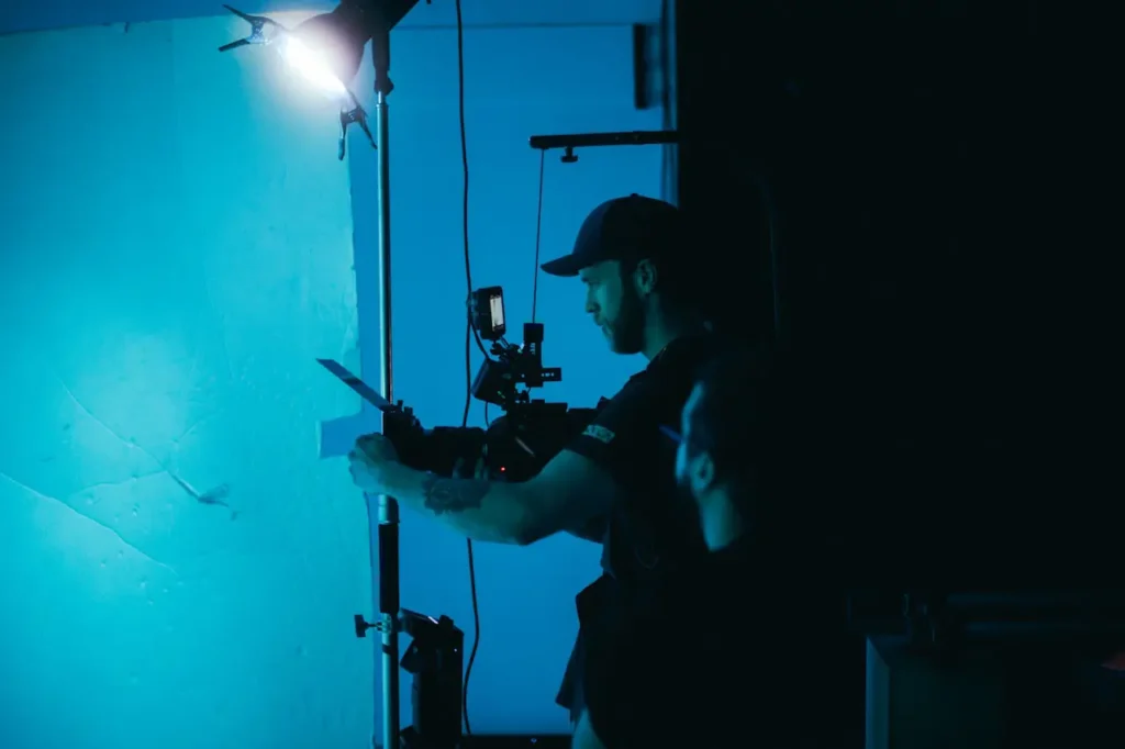 camera man in black shirt and cap