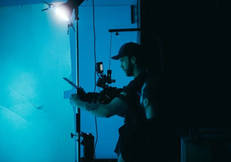 camera man in black shirt and cap